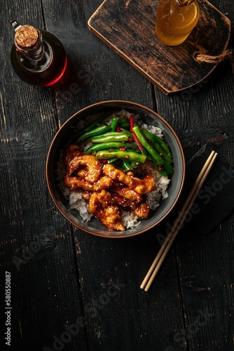 Portion of asian rice dish with chicken and green beans