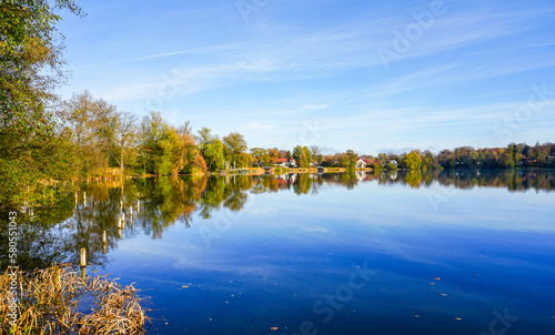 Wesslinger See in Wessling in the district of Starnberg in Bavaria. Autumn landscape by the lake. Idyllic nature. 