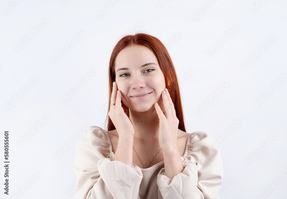 portrait of a young beautiful woman touching her face on white background, copy space portrait of a young beautiful woman touching her face on white background, copy space