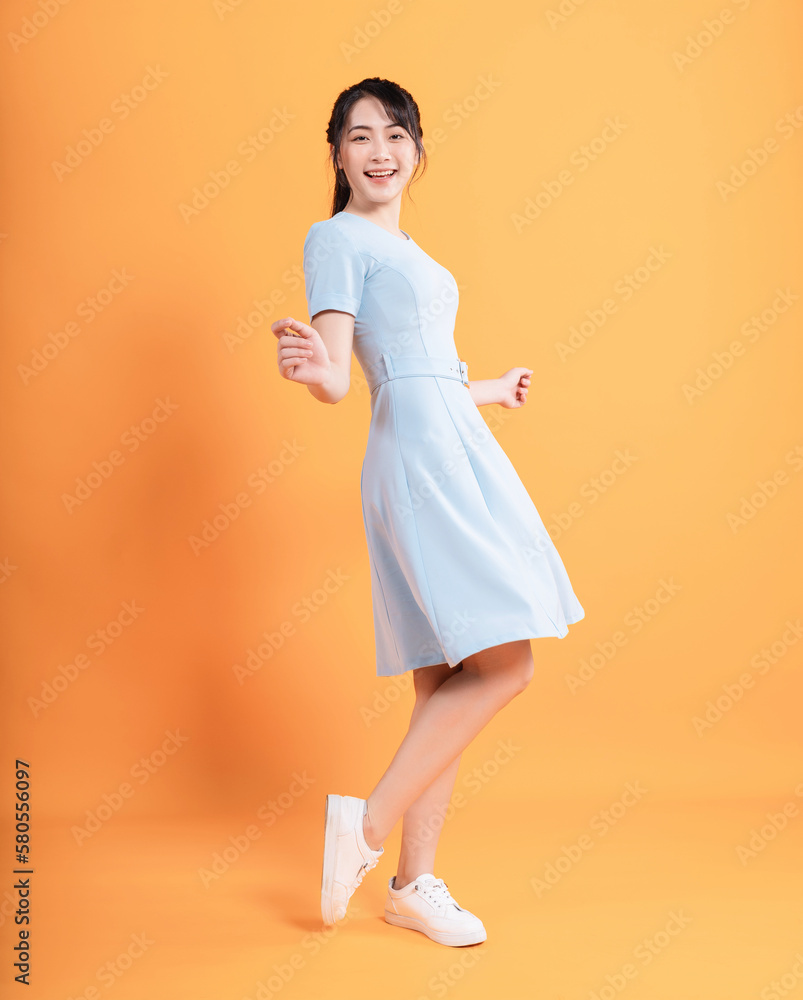 Young Asian woman wearing dress on background Young Asian woman wearing dress on background
