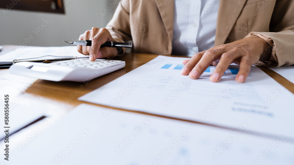 Fototapeta premium Investor calculating profits on stock market exchange.Investment planing and strategy concept, Financial data analysis graph business.