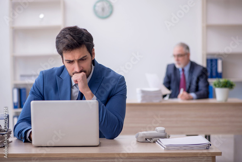 Two male colleagues working in the office