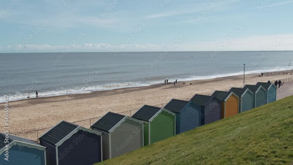 Sweeping panorama of the wooden beach huts on the promenade and