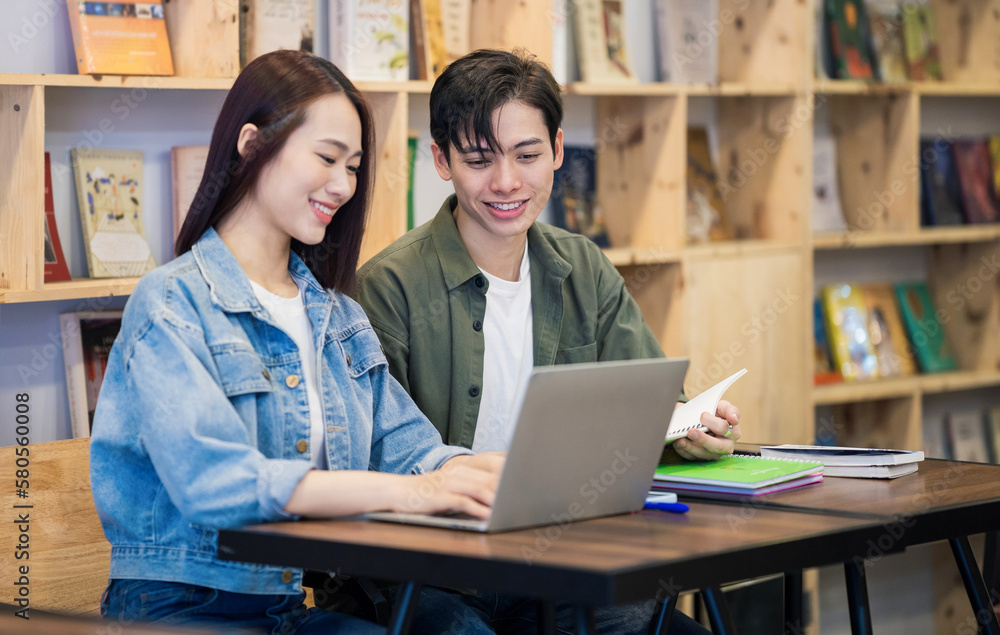 Young Asian couple studying at library Young Asian couple studying at library