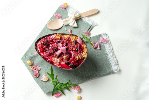 Presentation of an Easter egg from a pastry stuffed with cheesecake, and decorated with showy flowers
