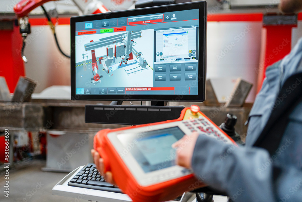 Monitor screen with engineer operating controller in industry Monitor screen with engineer operating controller in industry