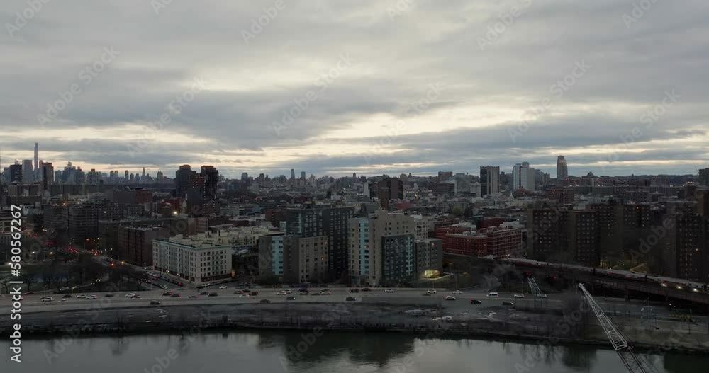 Aerial view over the river, towards traffic and a train, in gloomy Harlem, New York Aerial view over the river, towards traffic and a train, in gloomy Harlem, New York