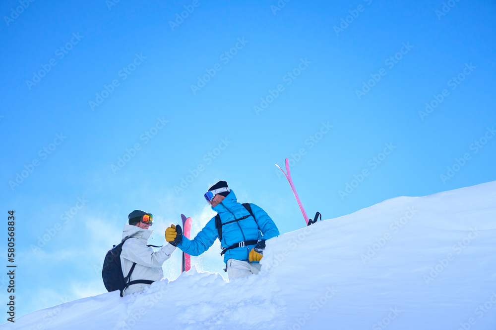 Happy mature couple holding hands and standing on snowcapped mountain Happy mature couple holding hands and standing on snowcapped mountain