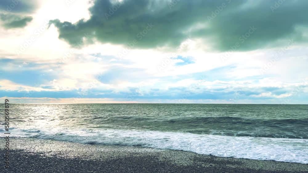 Powerful sea waves are crashing on the Black Sea coast. Waves splash on the beach with pebbles during a storm. Storm at sea. Panoramic view of the Black Sea. Russia. Sunset on the beach. 4K Powerful sea waves are crashing on the Black Sea coast. Waves splash on the beach with pebbles during a storm. Storm at sea. Panoramic view of the Black Sea. Russia. Sunset on the beach. 4K