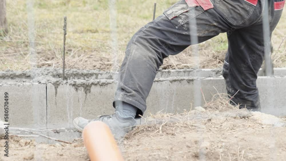 pouring concrete into an excavation in the ground. concreting of the foundation of the building pouring concrete into an excavation in the ground. concreting of the foundation of the building