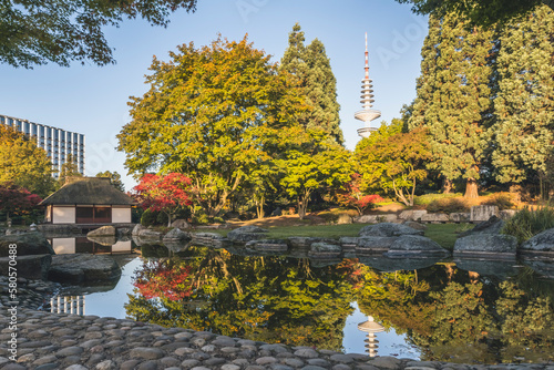 Germany, Hamburg, Japanese garden in Planten un Blomen park withHeinrich Hertz Tower visible in background photo