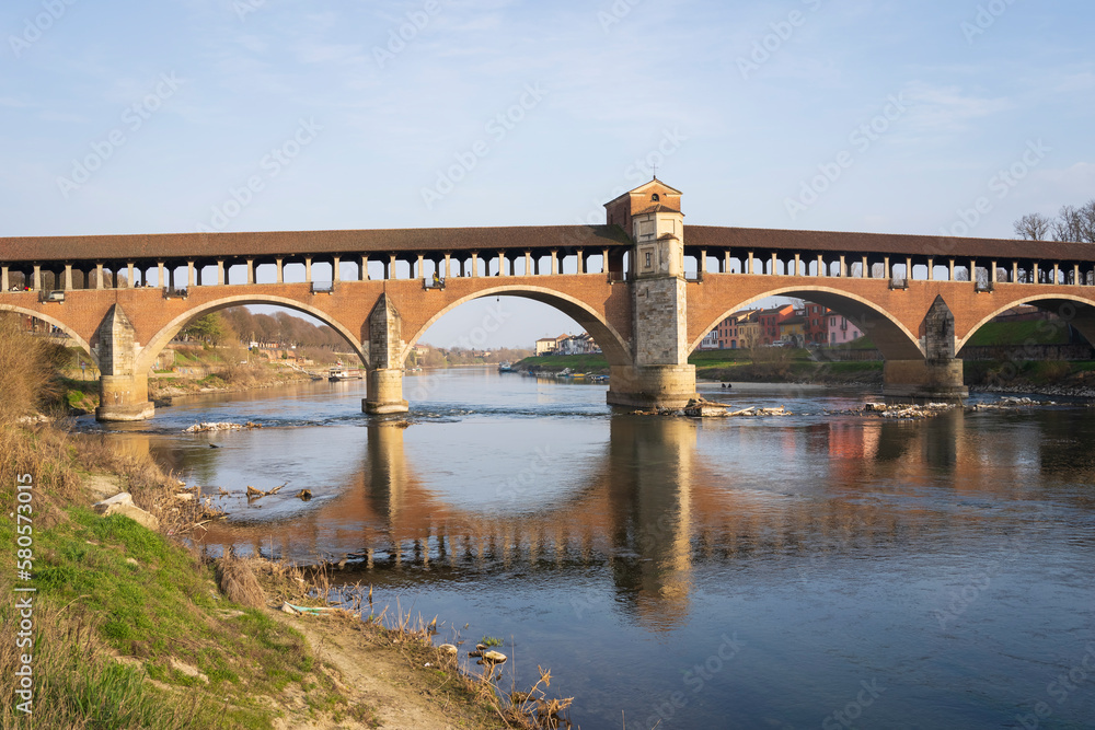 Ponte Coperto(covered bridge) is a bridge over the Ticino river in Pavia at sunny day, Lombardy, Pavia, Italy Ponte Coperto(covered bridge) is a bridge over the Ticino river in Pavia at sunny day, Lombardy, Pavia, Italy
