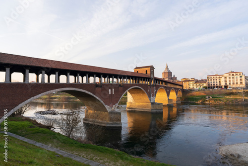 Skyline of Pavia , Ponte Coperto(covered bridge) is a bridge over the Ticino river in Pavia at sunny day, Pavia Cathedral background, Italy