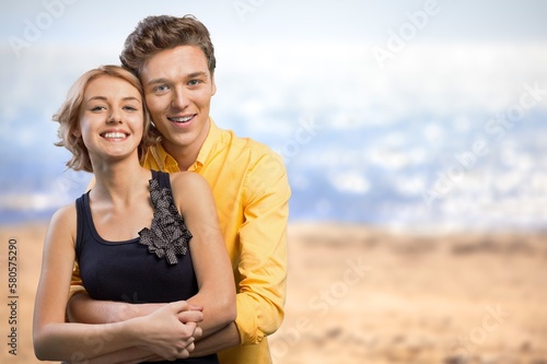 Young happy couple family on sea beach background.