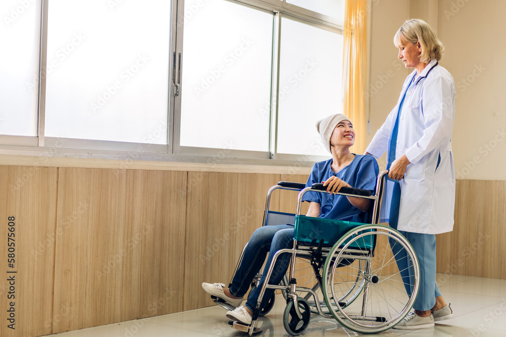Professional medical doctor team with stethoscope in uniform discussing with patient woman with cancer cover head with headscarf of chemotherapy cancer in hospital.health care concept Professional medical doctor team with stethoscope in uniform discussing with patient woman with cancer cover head with headscarf of chemotherapy cancer in hospital.health care concept