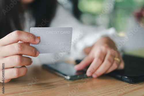 credit card payment concept young woman holding a credit card to pay for a coffee drink 