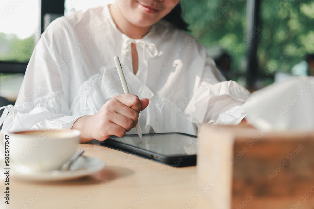 Young beautiful business woman working on laptop at coffee shop concept of independent living, working lifestyle
