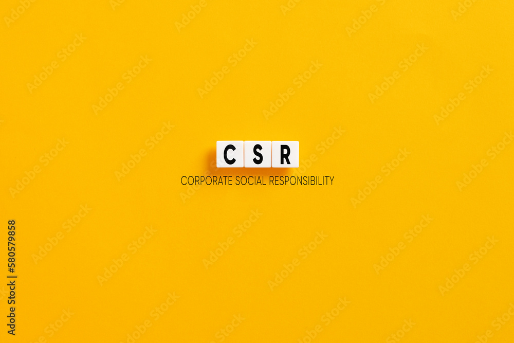 Fototapeta premium White letter blocks on yellow background with the acronym CSR corporate social responsibility.