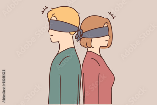 Blindfolded couple stand back to back 