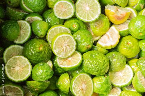 Much fresh bergamot fruit that is cut in half are stacked on top of each other ( Citrus,Citrus auraria,Citrus balincolong ,Fortunella sagittifolia,Papeda rumphii ) photo