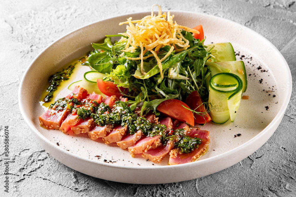 tuna slices with fresh vegetables and green beans salad on a plate. tuna slices with fresh vegetables and green beans salad on a plate.