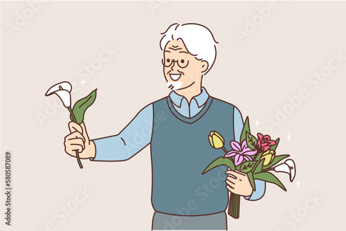 Smiling elderly man greeting with flower 