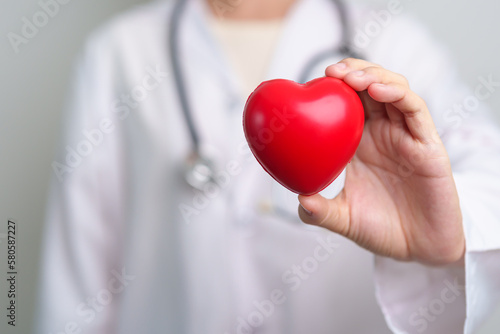 Doctor hand holding red heart shape in hospital. love, donor, world heart day, world health day, CSR donation and Insurance concepts