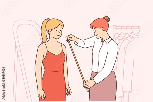 Seamstress measure client in atelier 