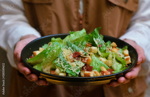 Caesar salad served with organic lettuce, crispy bread and sprinkled with cheese is a meal for health lovers.