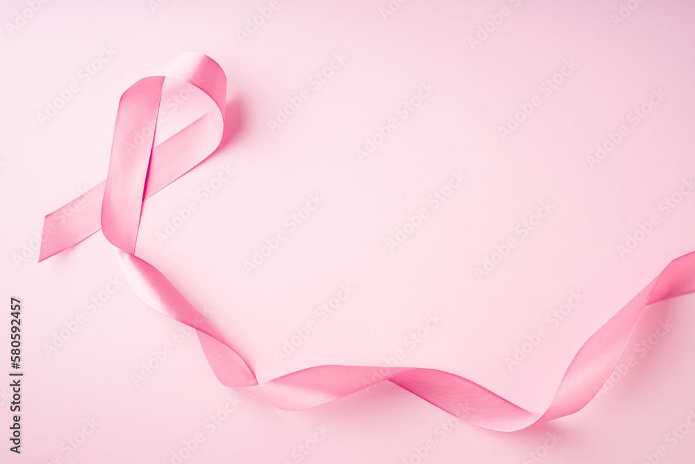 World breast cancer day concept with pink ribbon on pink background World breast cancer day concept with pink ribbon on pink background