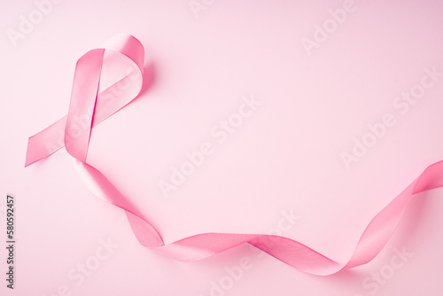 World breast cancer day concept with pink ribbon on pink background