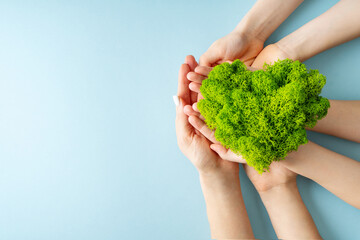 World earth day concept with green plant heart on blue background,