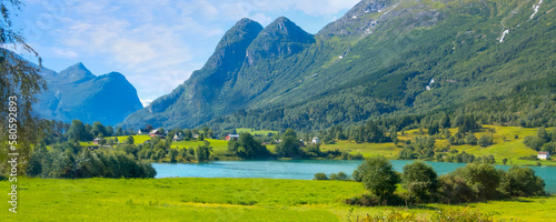 Norwegian landscape with Nordfjord fjord, summer mountains and village in Olden, Norway