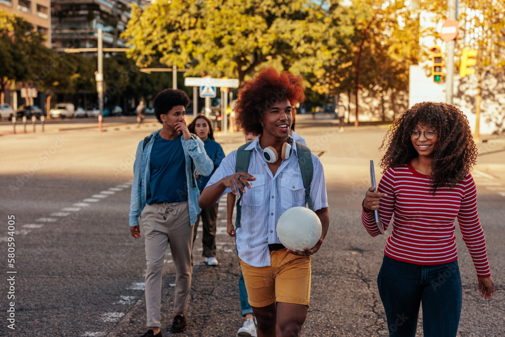 Fototapeta premium Happy students walking in city.