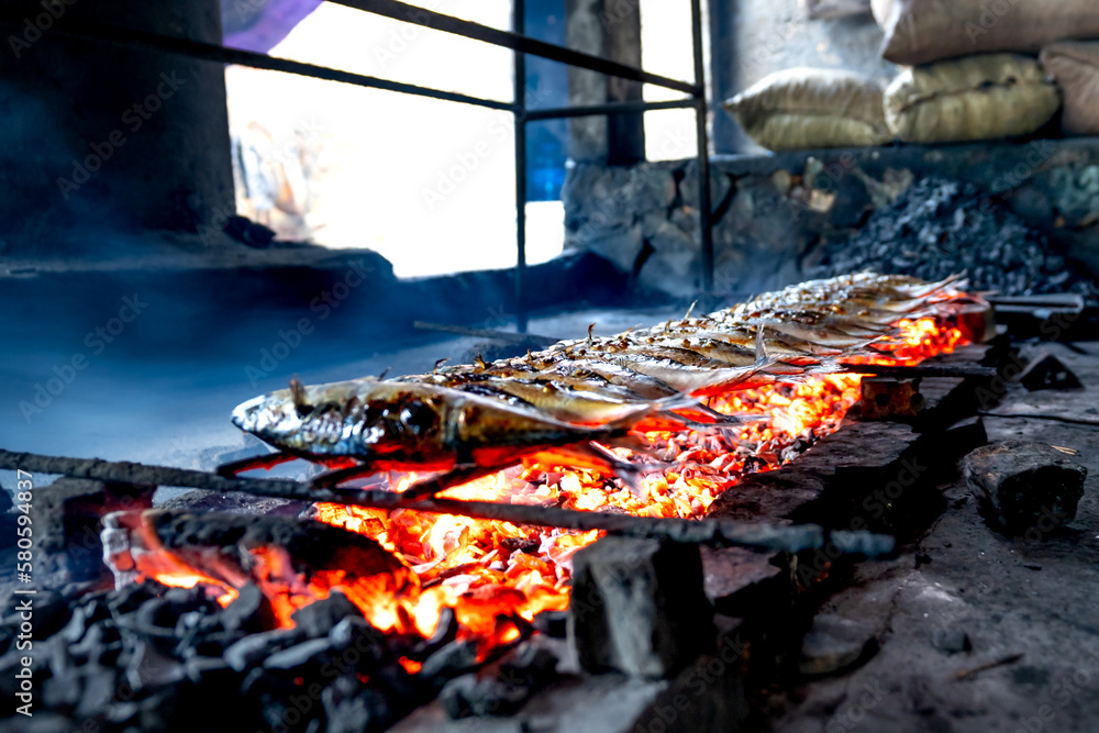 Fishermen grilled fresh fish on embers for sale at markets in Dien Van grilled fish village, Nghe An province, VN Fishermen grilled fresh fish on embers for sale at markets in Dien Van grilled fish village, Nghe An province, VN