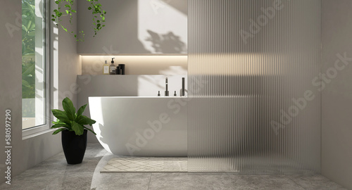 White oval bathtub, chrome shower head in modern loft gray wall bathroom, reeded glass partition with recessed wall shelf, hidden light and plant on marble floor in sunlight for interior background 3D photo