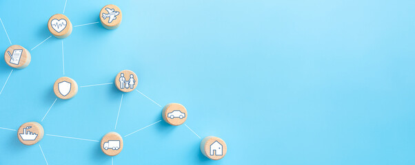 Insurance concept. Wooden blocks with insurance icons. family, life, car, travel, health and house insurance icons. blue background with copy space