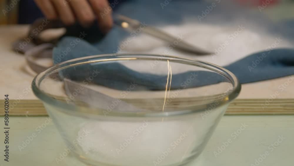 Adding ice cream emulsifier for mixing purpose in glass bowl Adding ice cream emulsifier for mixing purpose in glass bowl