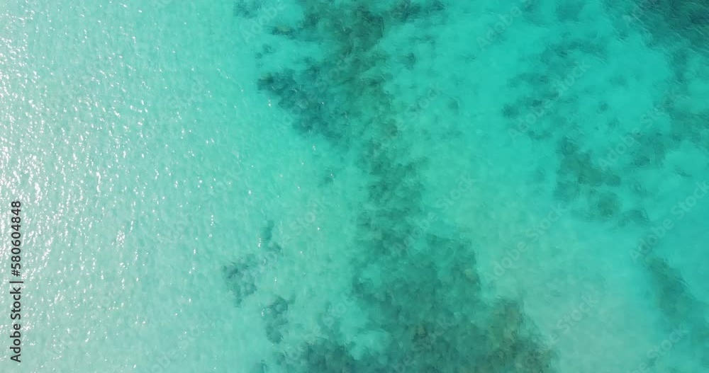 Aerial Birds Eye View Over Reflective Beautiful Blue Turquoise Ocean Waters Aerial Birds Eye View Over Reflective Beautiful Blue Turquoise Ocean Waters