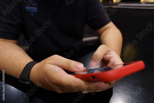 Man playing game on mobile phone. gamer boy playing video games holding Smartphone  working mobile devices. cell telephone technology e-commerce concept.