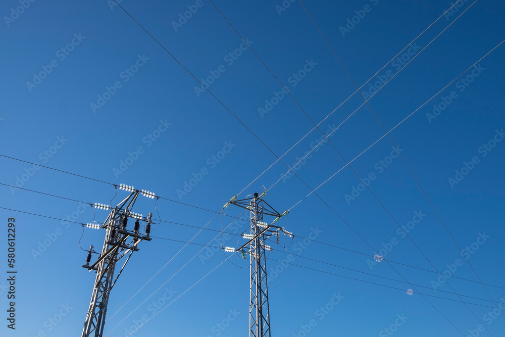 High voltage wires against the blue sky. Twisted wire with white bondage. Industry. Electricity.