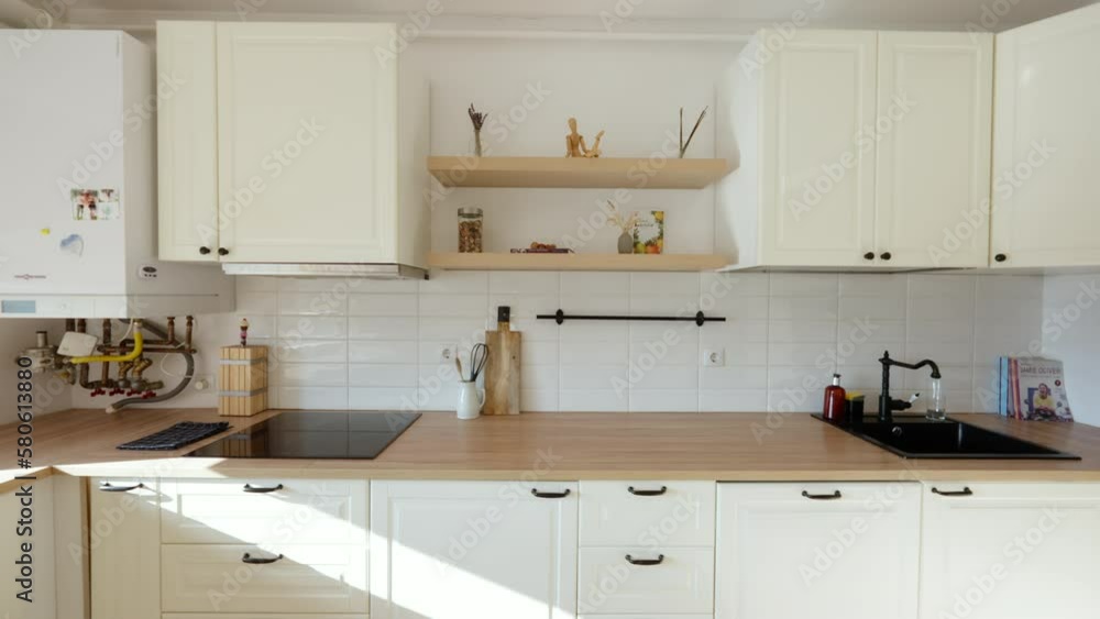 Slow establishing shot of a small kitchen area within an apartment Slow establishing shot of a small kitchen area within an apartment