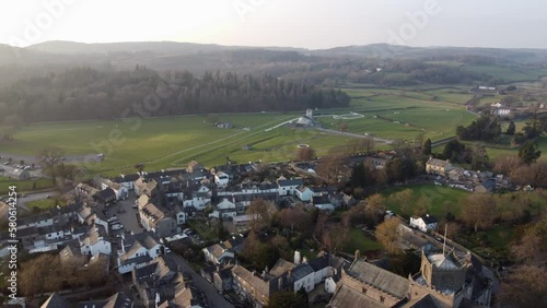 Cinematic aerial drone footage of Cartmel Village and Cartmel Priory. Shot at sunset. Cumbria UK. photo