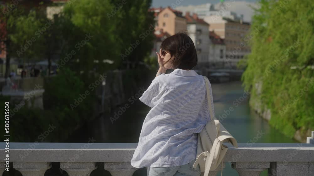 Beautiful female tourist on beautiful bridge in city enjoying her time on holidays Beautiful female tourist on beautiful bridge in city enjoying her time on holidays
