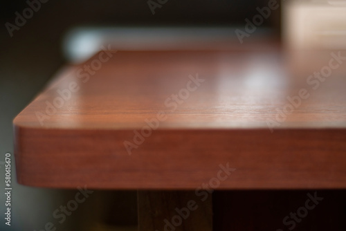 Template with an old table for a substrate. Angle at the edge of an old table top with a shallow depth of field.