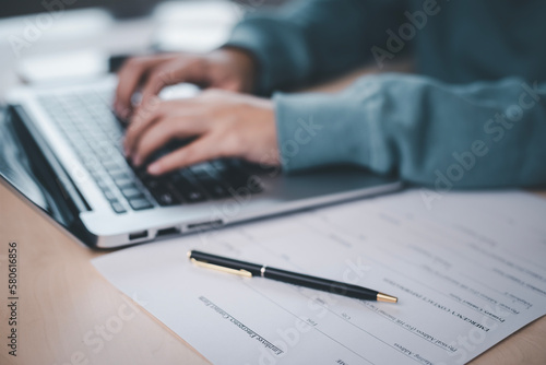 US IRS 1040 form or US Individual income tax Concept,accountant holding pen working on calculator business with data accounting documents and a laptop, pay tax in 2023 years,new year 2023 tax concept