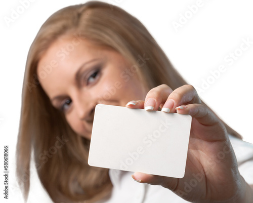 Young woman holding blank card and looking at camera