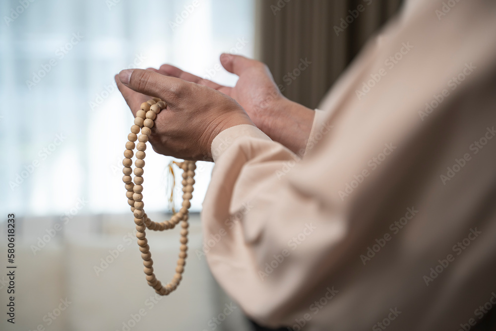 Muslim Man With Open Palm Praying at Home.