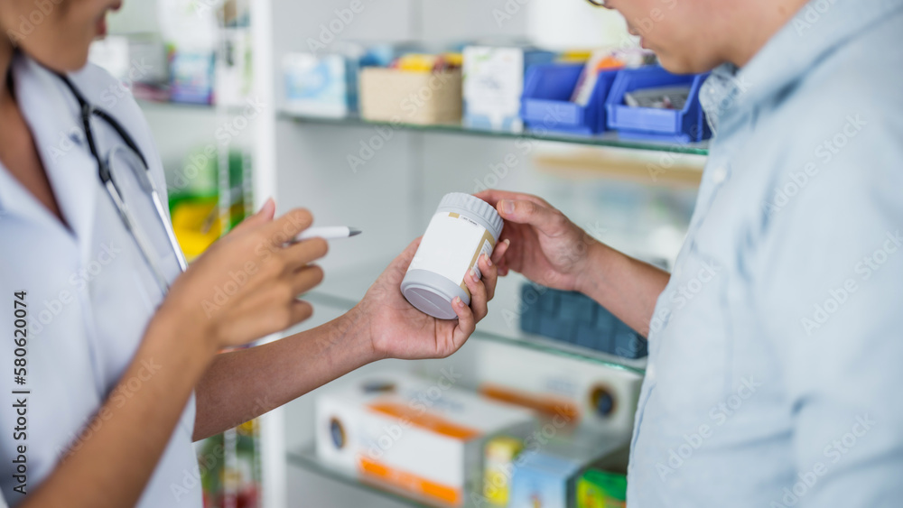 Asian woman pharmacist Helping Customer with Medicine at Pharmacy Drugstore Asian woman pharmacist Helping Customer with Medicine at Pharmacy Drugstore