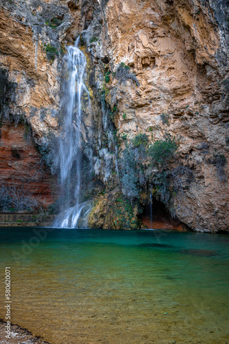 beautiful waterfall with lake in a rock amphitheater the cueva turche in spain